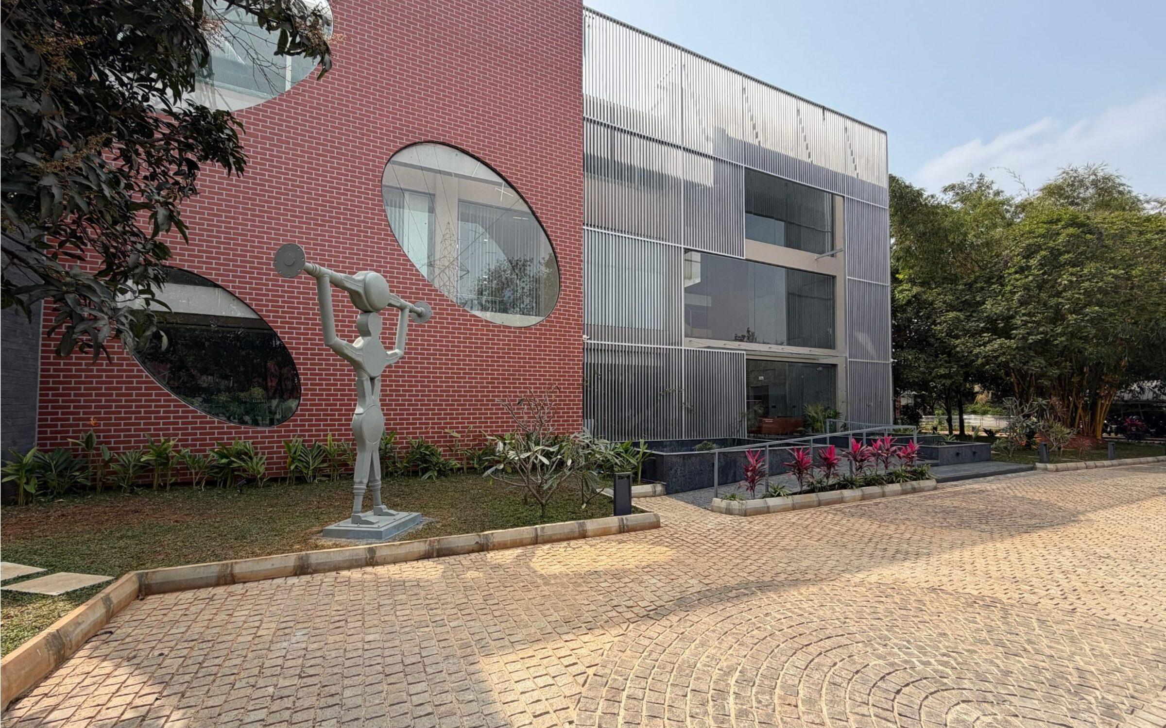 ETA Technology, Bengaluru: brick and metal-mesh facade with round windows